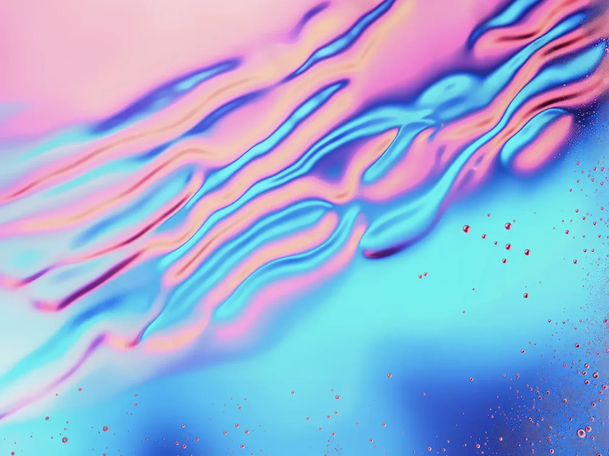 Bright abstract artwork featuring pink, blue, and orange fluid lines.