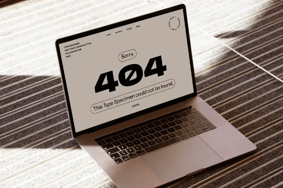 A laptop screen displaying a 404 error message with the text "This Type Specimen Could Not Be Found," indicating a broken link or missing page for a font.