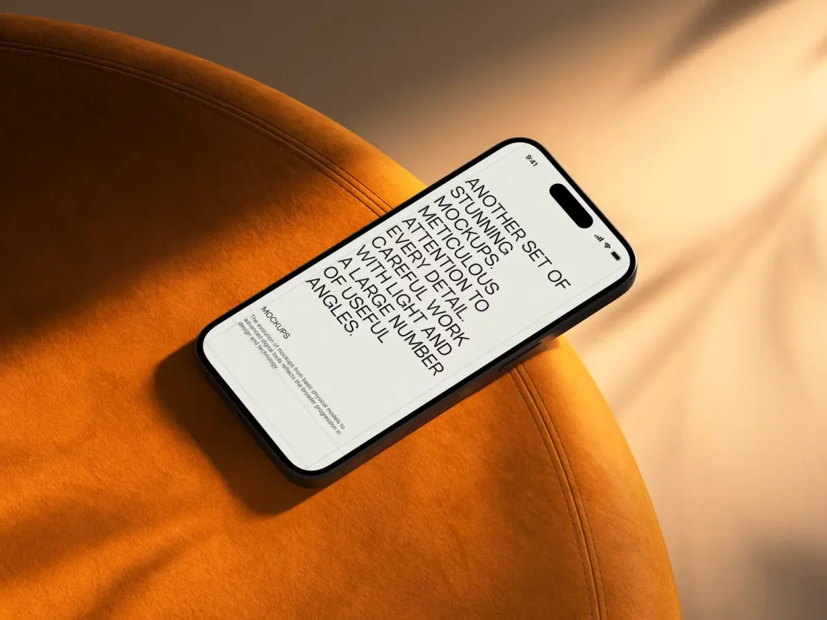 An iPhone mockup resting on a round, orange chair, displaying a website mockup with black text on a white screen, capturing the aesthetic of luxury and modern technology.